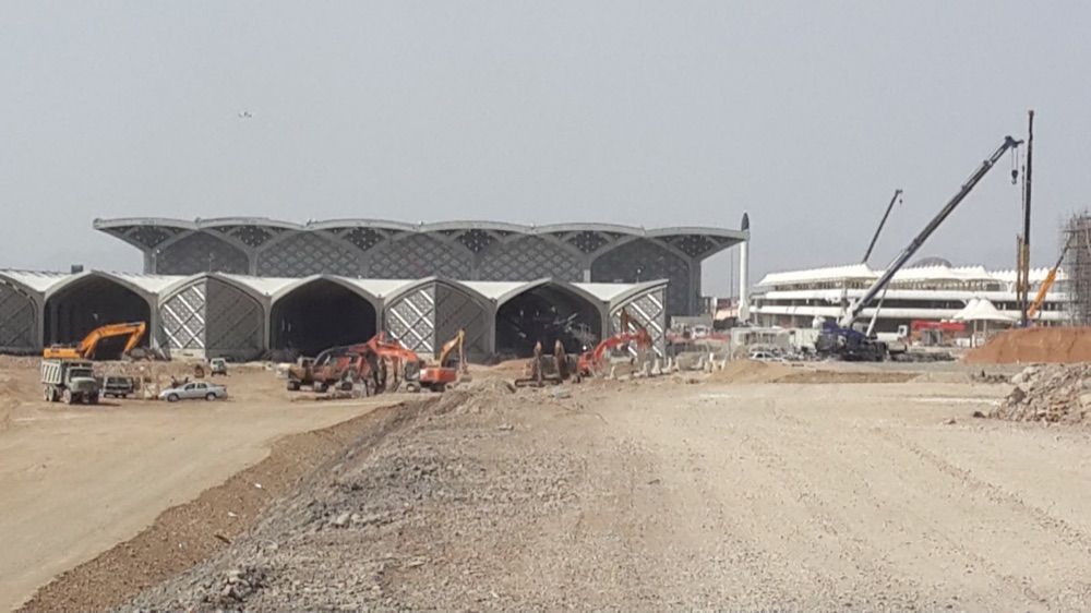 Wide view of the site with heavy earthmoving equipment